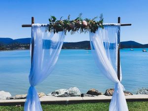 2 Post Bamboo Arbour, Sheer Draping, Real Touch Floral Arrangement